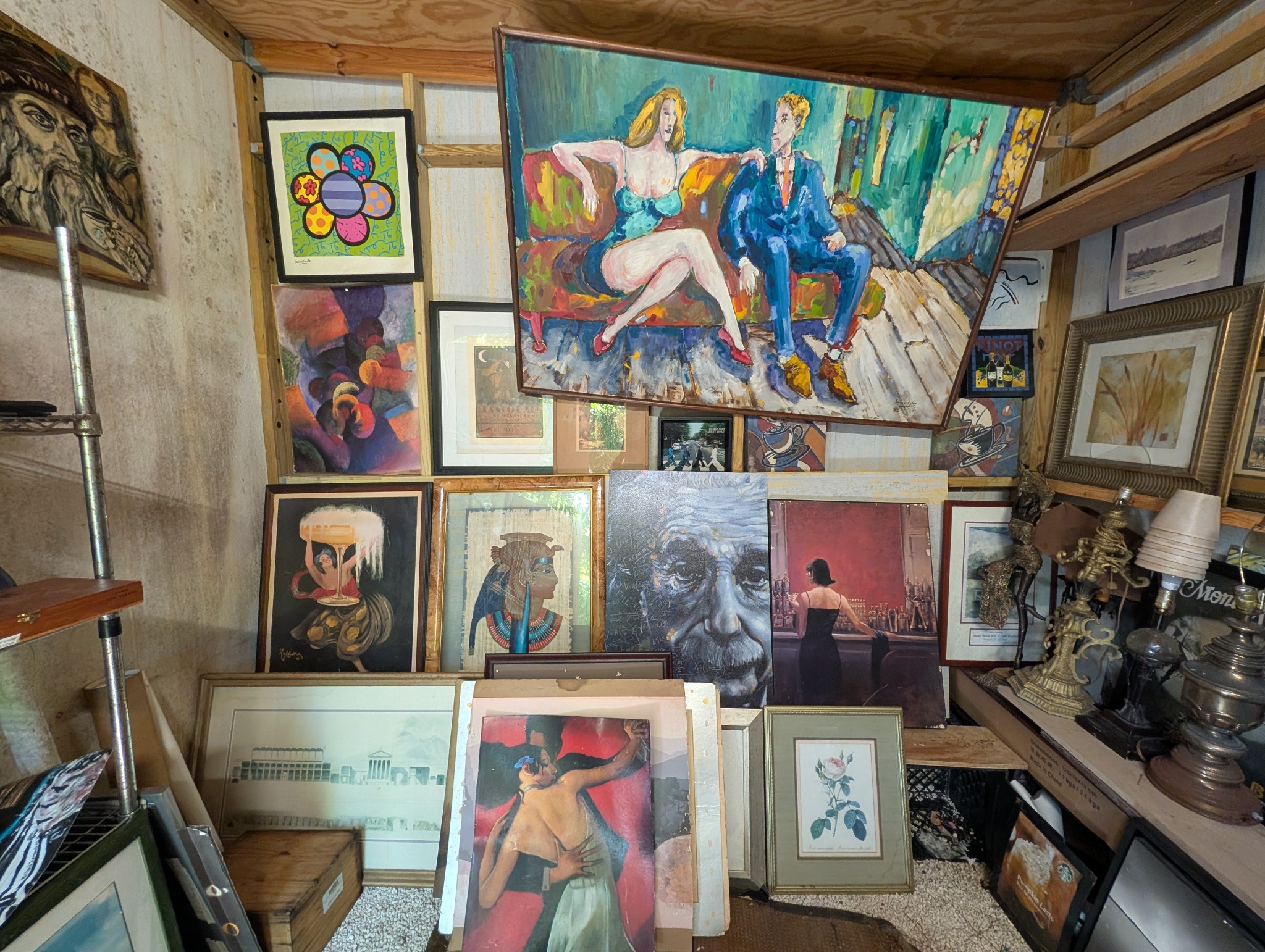A room filled with framed artwork in varied styles