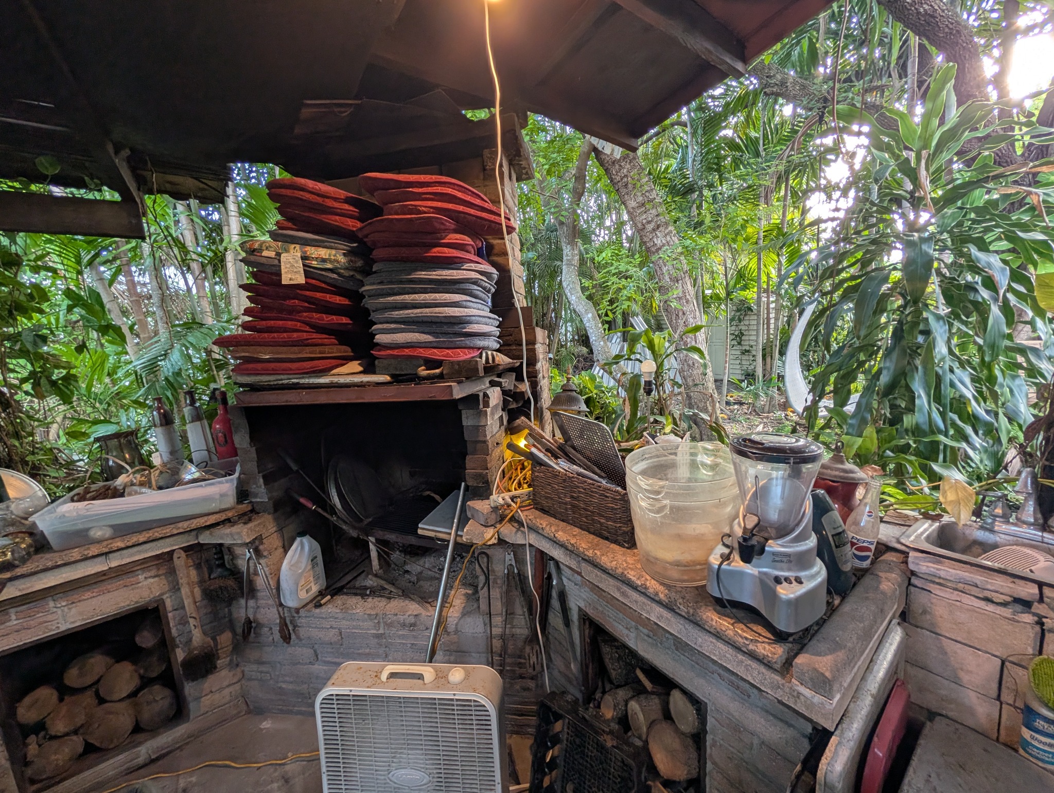 Outdoor cooking area with cushions and small appliances
